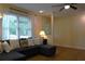 Bright living room featuring a large sectional sofa, ceiling fan, and natural light from the window at 1537 David Lee St, Acworth, GA 30102