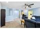 Bright living room with neutral paint, ceiling fan, and view into the kitchen at 1537 David Lee St, Acworth, GA 30102
