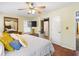 Comfortable main bedroom with a ceiling fan, TV, and ensuite bathroom access, designed for relaxation at 1537 David Lee St, Acworth, GA 30102