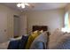 Main bedroom featuring plush bedding, natural light, and ample storage space from closet and dresser at 1537 David Lee St, Acworth, GA 30102