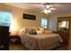 Inviting main bedroom showcasing natural light, ceiling fan, and wood-style floors and coordinated furnishings at 1537 David Lee St, Acworth, GA 30102