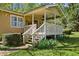 Inviting home entrance with a charming covered porch and landscaped pathway at 1537 David Lee St, Acworth, GA 30102