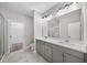 Bright bathroom features a double vanity with gray cabinets and a large mirror at 185 Bellehaven Dr, Woodstock, GA 30188