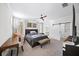 Cozy bedroom featuring a ceiling fan, a large window with natural light, and a sliding barn door at 185 Bellehaven Dr, Woodstock, GA 30188