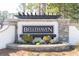 Bellehaven community entrance sign with brick and stone pillars and manicured landscaping at 185 Bellehaven Dr, Woodstock, GA 30188