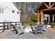 An outdoor fire pit area with Adirondack chairs, ideal for relaxing and entertaining at 185 Bellehaven Dr, Woodstock, GA 30188