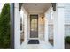 Close-up of the front door featuring stone accents and classic architectural details at 185 Bellehaven Dr, Woodstock, GA 30188