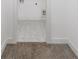 Hallway with neutral carpet, white walls, and view of a laundry room with tile floors at 185 Bellehaven Dr, Woodstock, GA 30188