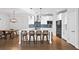 Spacious kitchen with white cabinets, stainless steel appliances, and an island with bar stools at 185 Bellehaven Dr, Woodstock, GA 30188