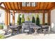 Covered outdoor kitchen with a built-in grill, dining tables, seating, and string lights at 185 Bellehaven Dr, Woodstock, GA 30188