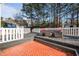 The backyard deck with outdoor seating and white railing has red brick detail at 2524 Columbia Crossing Ct, Decatur, GA 30034