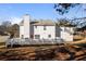 The backyard has a deck and a white house with a chimney and siding at 2524 Columbia Crossing Ct, Decatur, GA 30034