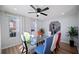 Dining room with a modern glass table and vibrant mix-and-match chairs at 2524 Columbia Crossing Ct, Decatur, GA 30034