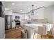 Bright kitchen features stainless appliances, wood floors, and a breakfast bar with stylish seating at 2524 Columbia Crossing Ct, Decatur, GA 30034