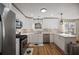Modern kitchen featuring stainless steel appliances, white cabinets, and marble countertops at 2524 Columbia Crossing Ct, Decatur, GA 30034