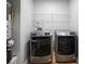 This laundry room has a washer and dryer and a white wire rack on the wall at 2524 Columbia Crossing Ct, Decatur, GA 30034