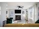 Cozy living room with a fireplace, ceiling fan, and natural light from the windows at 2524 Columbia Crossing Ct, Decatur, GA 30034