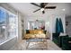 Bright living room featuring modern decor, a ceiling fan, and large windows at 2524 Columbia Crossing Ct, Decatur, GA 30034