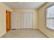 Bedroom with carpeted floors, closet doors, and lots of natural light at 6330 Oak View Dr, Cumming, GA 30041