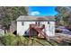 View of the back of a two-story home featuring a wooden deck with staircase at 6330 Oak View Dr, Cumming, GA 30041