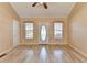 Bright living room with hardwood floors, neutral walls, natural light and front door at 6330 Oak View Dr, Cumming, GA 30041