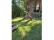 Well-maintained backyard featuring green grass, drainage, and a covered outdoor structure at 1655 Butler Bridge Rd, Covington, GA 30016
