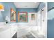 Bright bathroom with a soaking tub, separate shower, and modern fixtures for a spa-like experience at 1655 Butler Bridge Rd, Covington, GA 30016