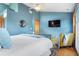 Tranquil bedroom with vibrant blue walls, plush bedding, and a relaxing atmosphere at 1655 Butler Bridge Rd, Covington, GA 30016
