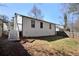 View of the fenced backyard with deck access, stairs, shed and partial grass at 2070 Charles Cudd Ct, Lithonia, GA 30058