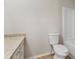 Bathroom featuring a vanity with solid surface top, toilet, and white tiled shower/tub at 2070 Charles Cudd Ct, Lithonia, GA 30058