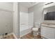 Bright bathroom featuring a tub, toilet, modern vanity with granite countertop, and wood look flooring at 2070 Charles Cudd Ct, Lithonia, GA 30058