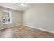 Bedroom with wood-look flooring, neutral walls, a window, and a ceiling light fixture at 2070 Charles Cudd Ct, Lithonia, GA 30058