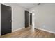 Bedroom featuring wood-look floors, neutral walls, gray doors, and an open doorway at 2070 Charles Cudd Ct, Lithonia, GA 30058