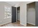 Bedroom with a gray door opening to closet space and a bright window with an exterior view at 2070 Charles Cudd Ct, Lithonia, GA 30058