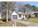 A cozy single-story house with neutral paint, neat landscaping, and a driveway at 2070 Charles Cudd Ct, Lithonia, GA 30058