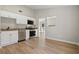 Bright kitchen with stainless steel appliances, white cabinets, and an open floor plan at 2070 Charles Cudd Ct, Lithonia, GA 30058