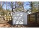 Backyard shed for extra storage with a secure door surrounded by a fenced backyard at 2070 Charles Cudd Ct, Lithonia, GA 30058