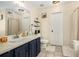 Stylish bathroom with double vanity, warm lighting, decorative shelving and tiled floors at 7760 Poppy Dr, Winston, GA 30187