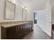 A bright bathroom featuring dual sinks, granite countertops, and access to a walk-in closet at 1080 Peachtree Ne St # 2003, Atlanta, GA 30309
