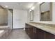A spacious bathroom features dual sinks with granite countertops, tiled floors, and a glass-enclosed shower at 1080 Peachtree Ne St # 2003, Atlanta, GA 30309