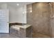 A stylish bathroom features a tiled shower with glass enclosure and a luxurious soaking tub at 1080 Peachtree Ne St # 2003, Atlanta, GA 30309