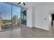 A bedroom with hardwood floors and a large window featuring scenic city views at 1080 Peachtree Ne St # 2003, Atlanta, GA 30309