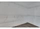 Walk-in closet with built in shelving and modern floors at 1080 Peachtree Ne St # 2003, Atlanta, GA 30309