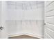 A walk-in closet with white walls, wire shelving, and hardwood floors at 1080 Peachtree Ne St # 2003, Atlanta, GA 30309