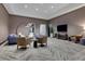 A well-appointed community room with stylish seating, modern decor, and a large TV at 1080 Peachtree Ne St # 2003, Atlanta, GA 30309