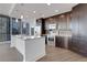 Modern kitchen featuring stainless steel appliances, dark wood cabinets, and a center island at 1080 Peachtree Ne St # 2003, Atlanta, GA 30309
