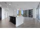 Open concept kitchen with island, sleek cabinets and floor-to-ceiling windows boasting city views at 1080 Peachtree Ne St # 2003, Atlanta, GA 30309