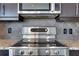 Close up on stainless steel Bosch stove with granite countertops and tile backsplash at 1080 Peachtree Ne St # 2003, Atlanta, GA 30309