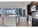 Modern kitchen with stainless steel appliances, island and floor-to-ceiling windows offering city views at 1080 Peachtree Ne St # 2003, Atlanta, GA 30309
