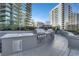 A full outdoor kitchen featuring stainless steel grill, sink, and countertop space at 1080 Peachtree Ne St # 2003, Atlanta, GA 30309